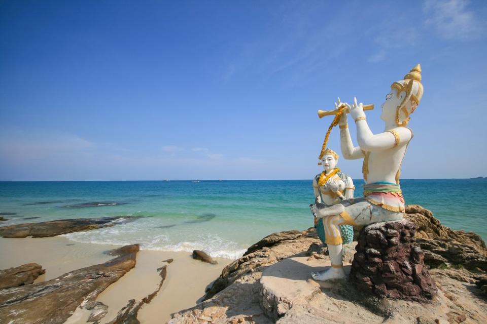 Buddhist figures on a beach in Rayong, Eastern Thailand