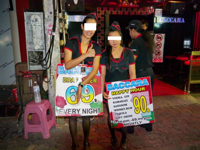 Girls advertising beer prices outside a gogo bar on Walking Street, Pattaya