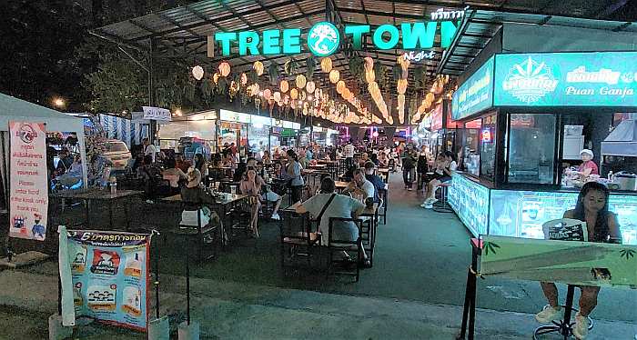 Food court with people dining at night time at Tree Town Night Market in Pattaya 