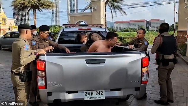 Pictured: Oeaop was arrested and taken to the police station in a pickup truck in Pattaya