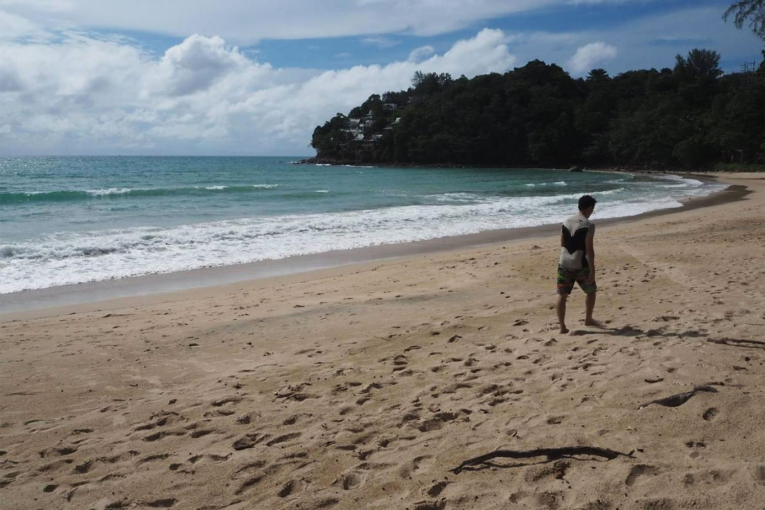 A man walks on a nearly empty Kamala beach in Phuket. (Photo by Dusida Worrachaddejchai)