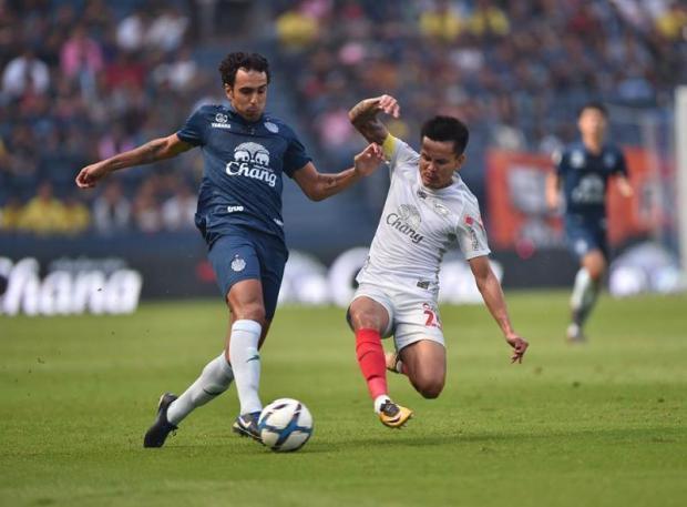 Buriram striker Diogo Luis Santo, left, in action against Chonburi.  photo: credit