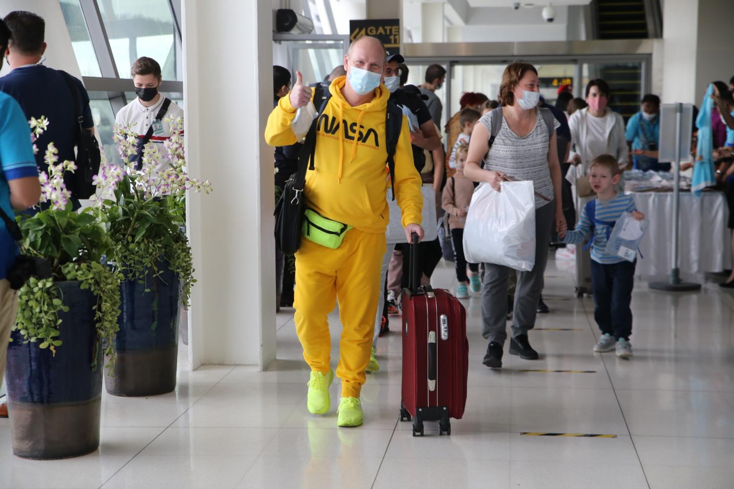 Tourists from Russia are greeted by airport officials on arrival at Phuket International Airport.