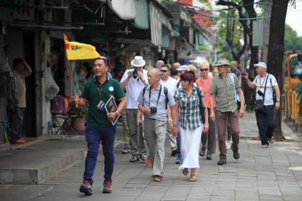 A tour group visits Pak Khlong Talat area. Improving safety and security is one of the tactics experts have prescribed to draw more visitors to Thailand. CHANAT KATANYU